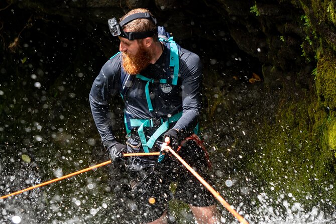 Chasing Waterfalls:Wild Hawaii Rappelling - At the waterfall: harness and rope setup before anyone goes down